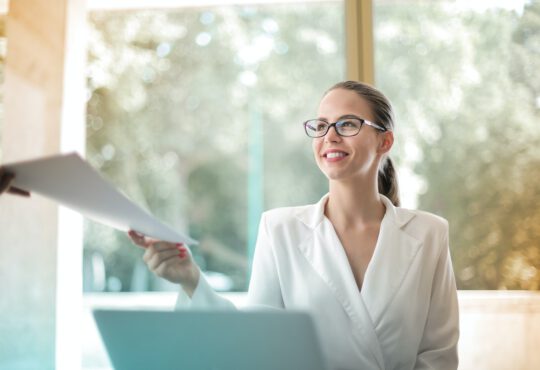 positive-businesswoman-doing-paperwork-in-office