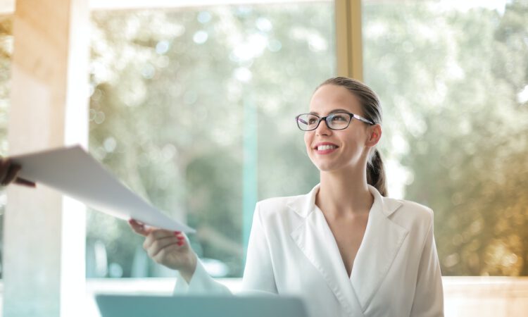 positive-businesswoman-doing-paperwork-in-office